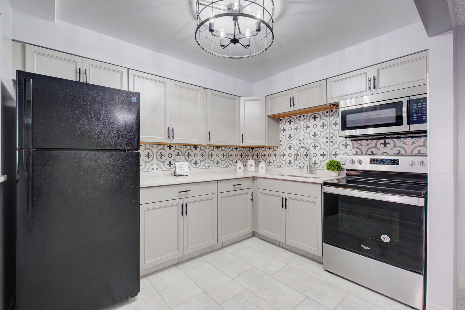 9708 Nottingham Avenue, Unit 5 Chicago Ridge, IL 60415 - Photo 12 of 16 a kitchen with stainless steel appliances granite countertop a refrigerator a stove a sink and a microwave