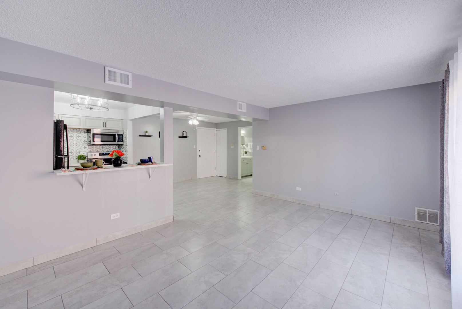 9708 Nottingham Avenue, Unit 5 Chicago Ridge, IL 60415 - Photo 13 of 16 a view of a big room with kitchen and natural light