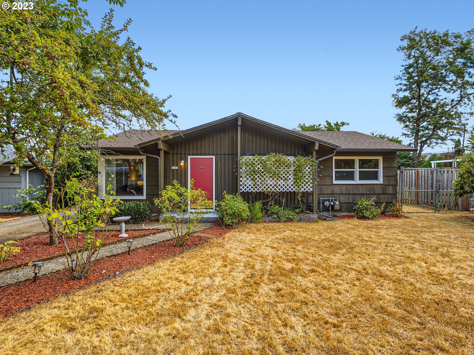 2546 Southeast 176th Place Portland, OR 97236 - Photo 1 of 24 a front view of house with yard and trees around