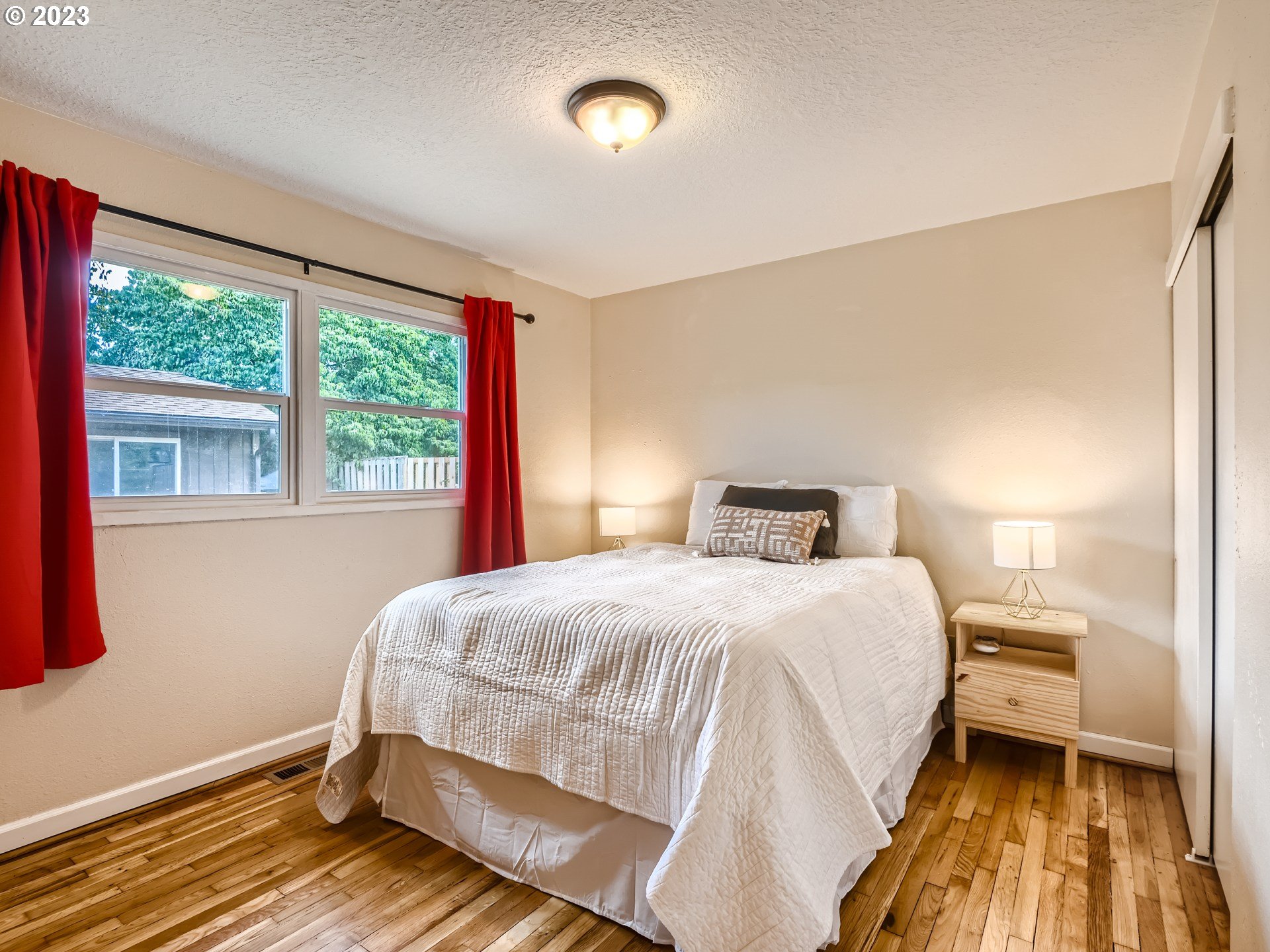 2546 Southeast 176th Place Portland, OR 97236 - Photo 12 of 24 a bedroom with a bed and a large window