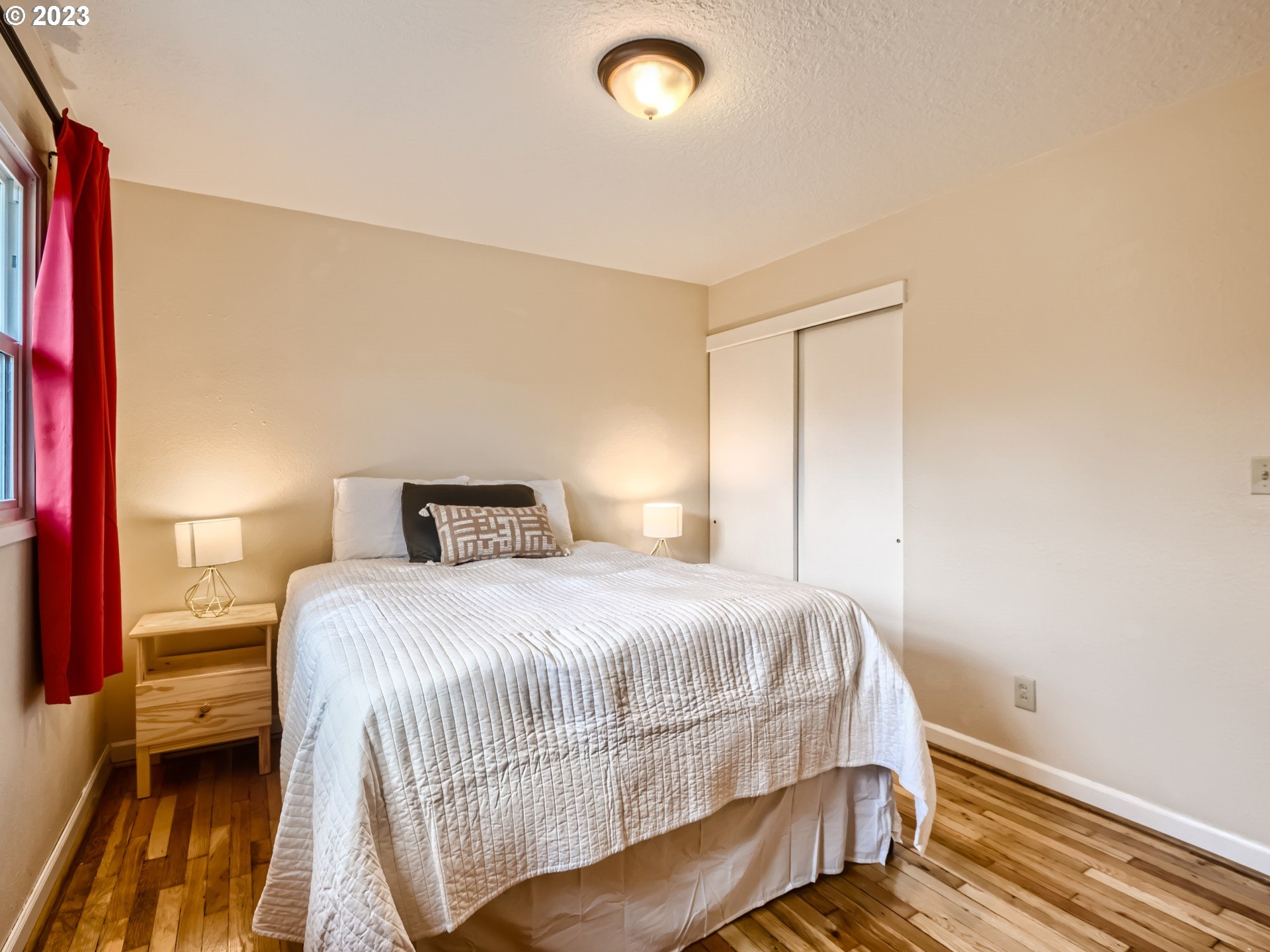2546 Southeast 176th Place Portland, OR 97236 - Photo 13 of 24 a bedroom with a bed and wooden floor