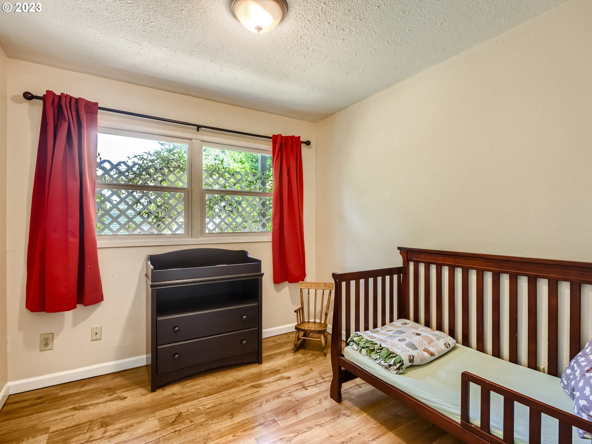 2546 Southeast 176th Place Portland, OR 97236 - Photo 16 of 24 a living room with a bed and a window