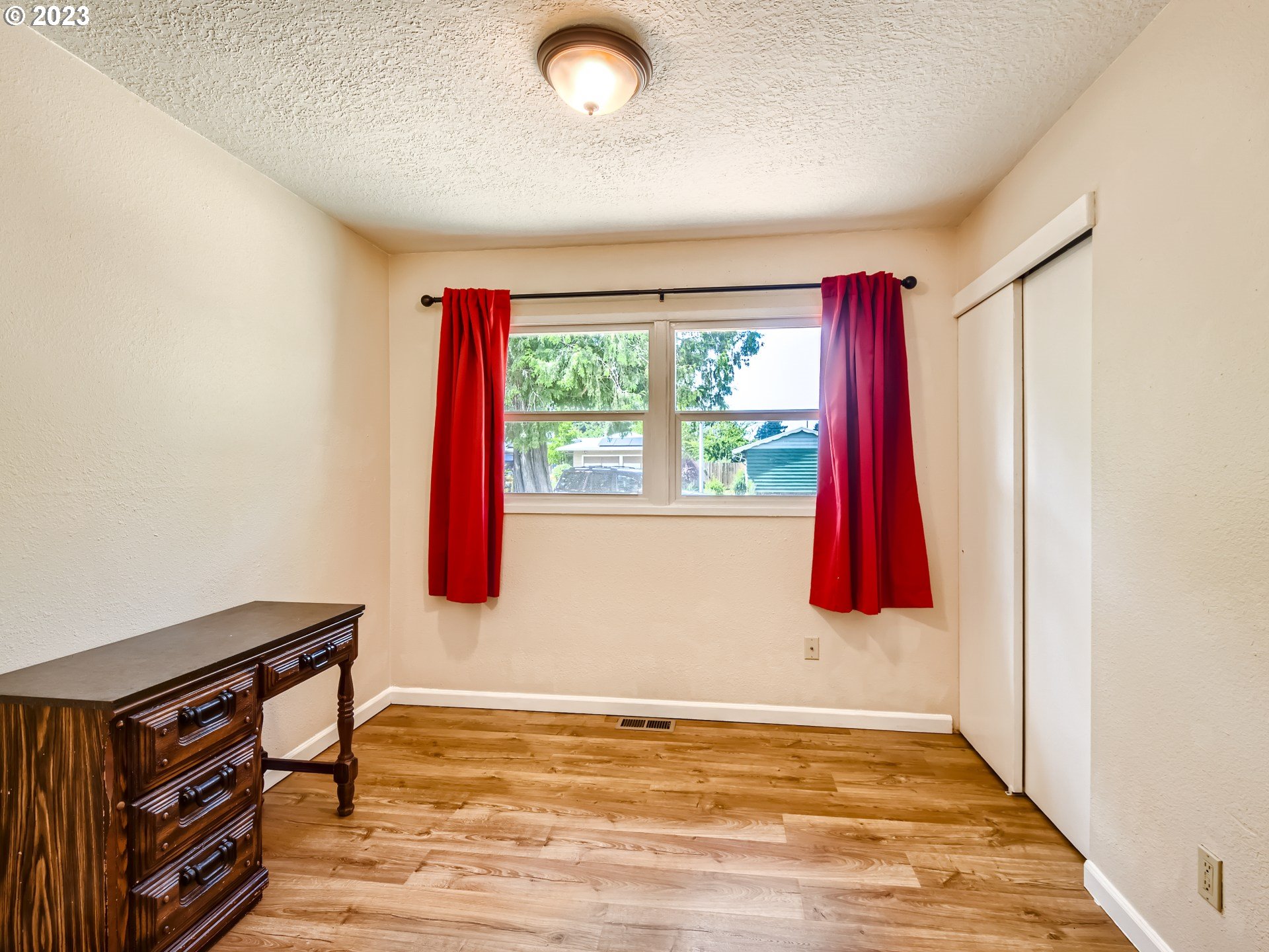 2546 Southeast 176th Place Portland, OR 97236 - Photo 17 of 24 a room with a bed and a window