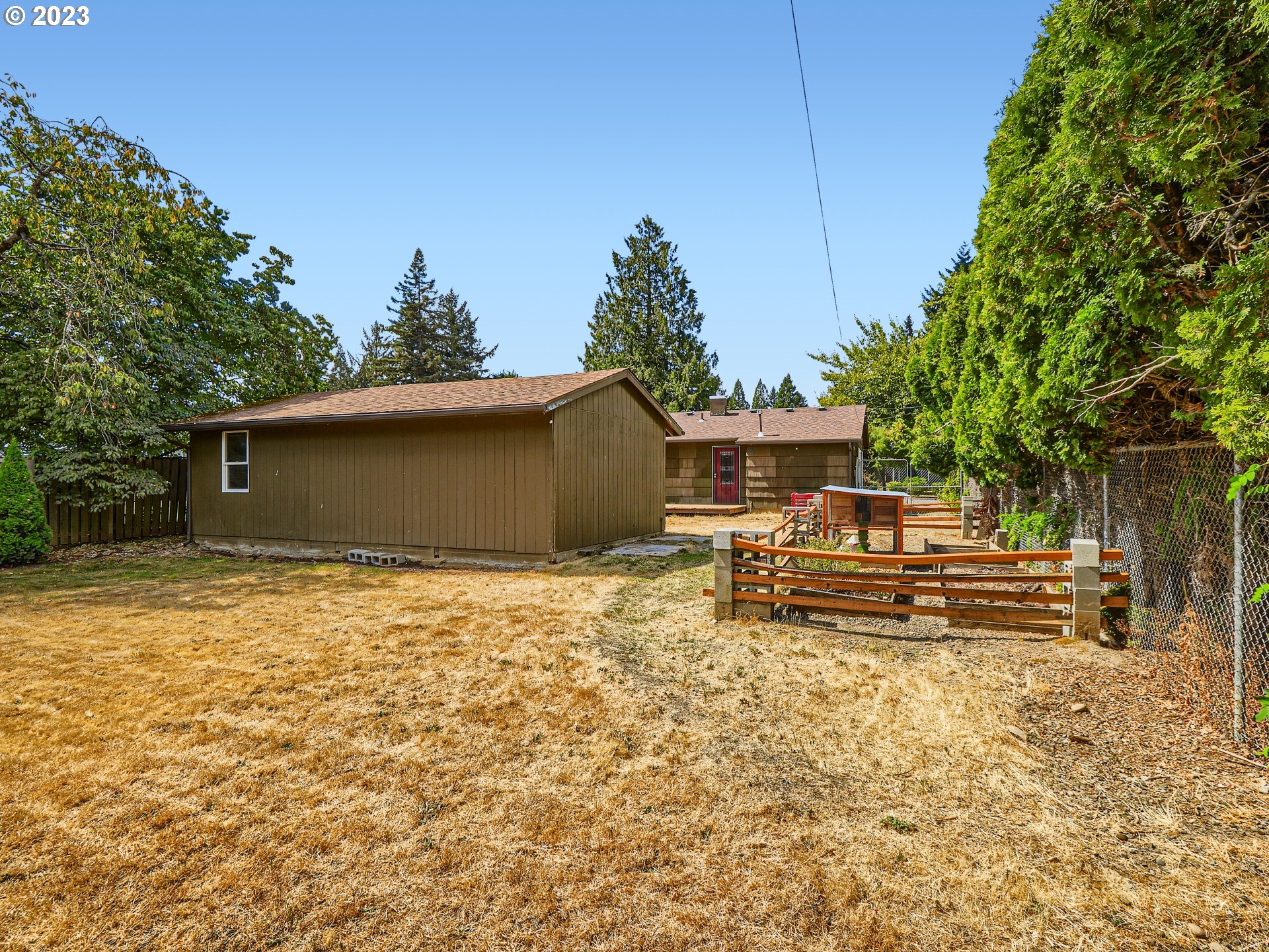 2546 Southeast 176th Place Portland, OR 97236 - Photo 22 of 24 a view of a house with backyard and sitting area