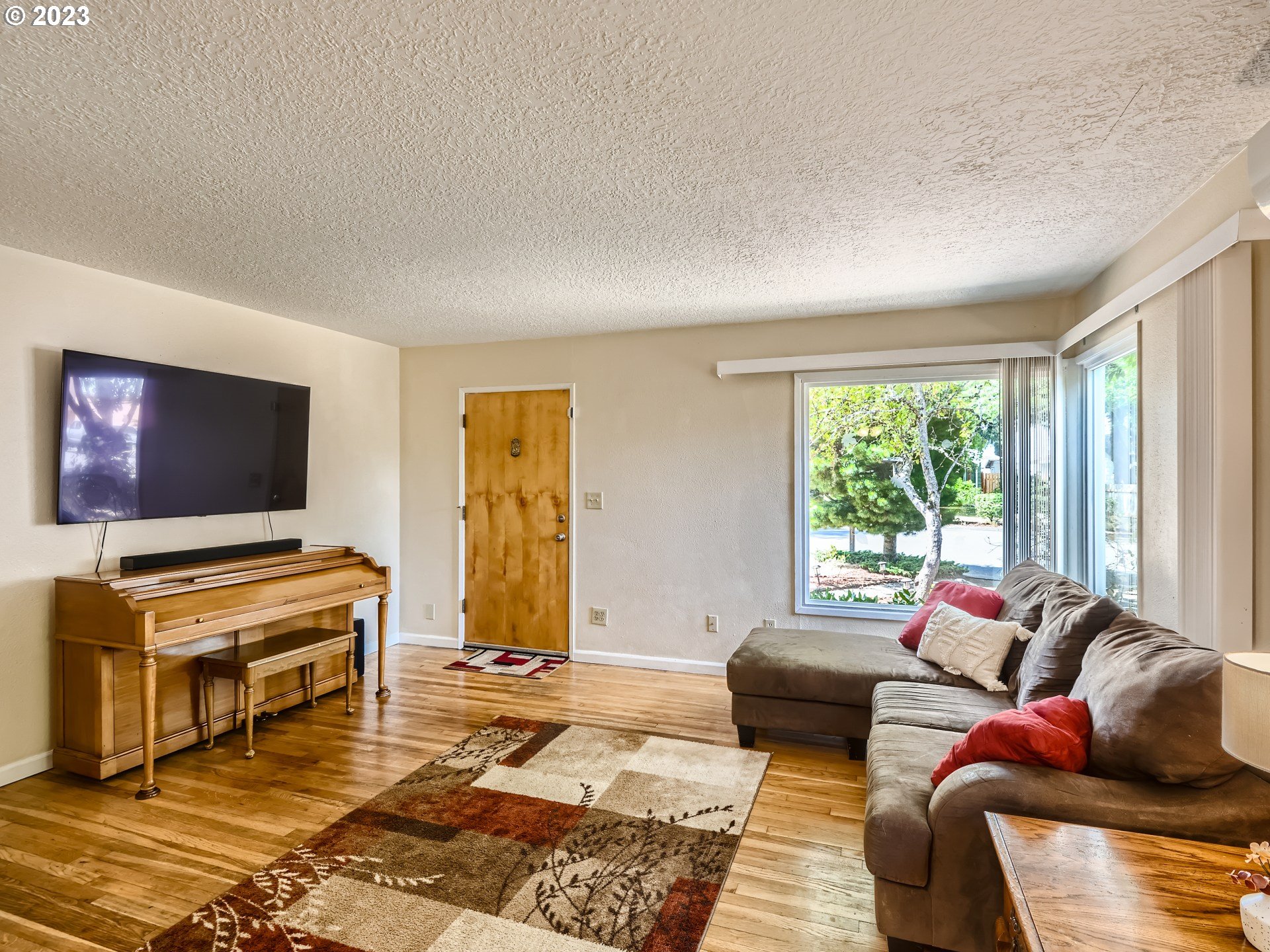 2546 Southeast 176th Place Portland, OR 97236 - Photo 5 of 24 a living room with furniture and a flat screen tv