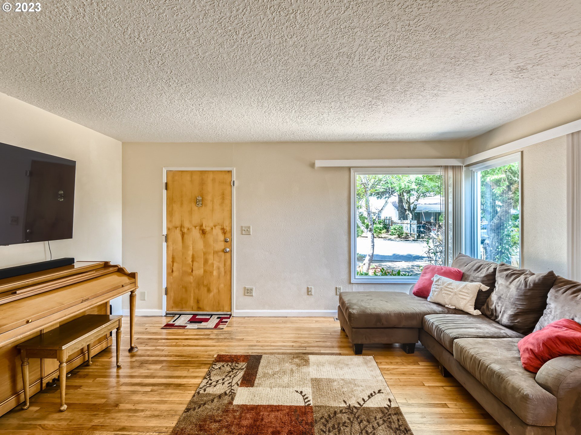 2546 Southeast 176th Place Portland, OR 97236 - Photo 6 of 24 a living room with furniture and a flat screen tv