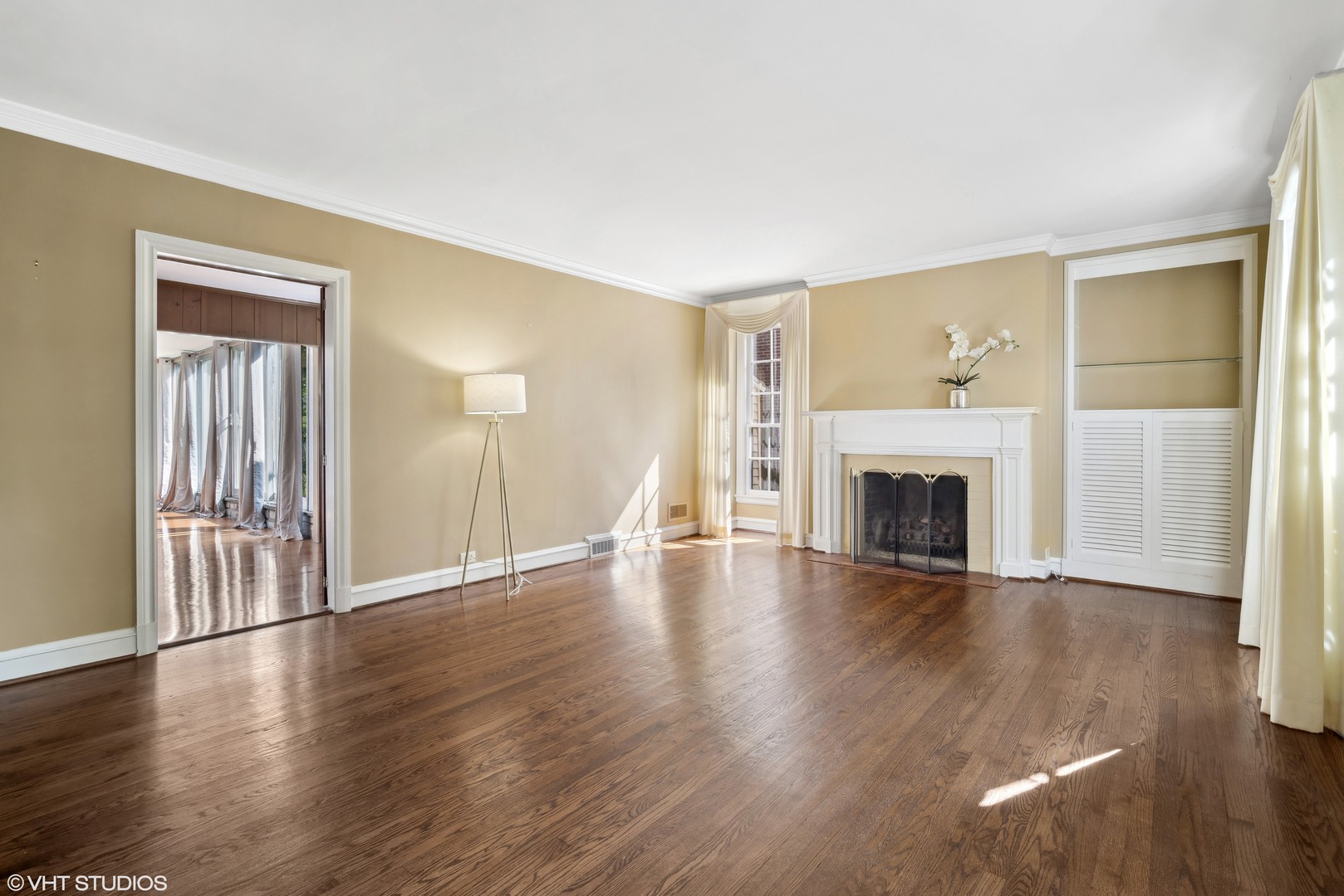 715 Wagner Road Glenview, IL 60025 - Photo 3 of 21 a view of an empty room with wooden floor fireplace and a window