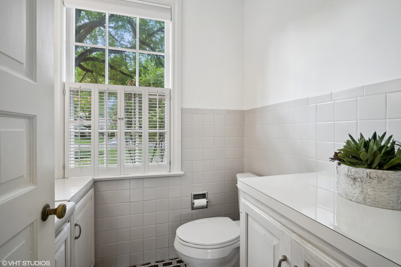 715 Wagner Road Glenview, IL 60025 - Photo 9 of 21 a bathroom with a granite countertop toilet a sink and a window