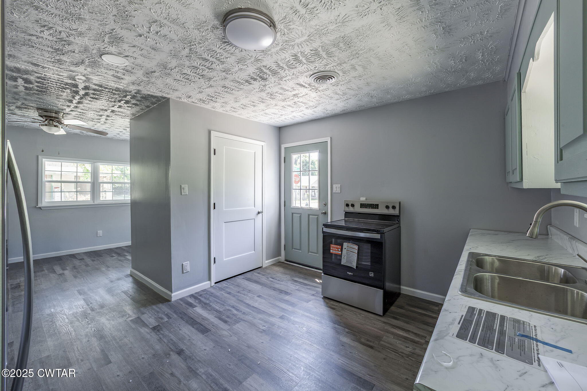 115 Neff Street Jackson, TN 38301 - Photo 13 of 23 a kitchen that has a fridge and wooden floor