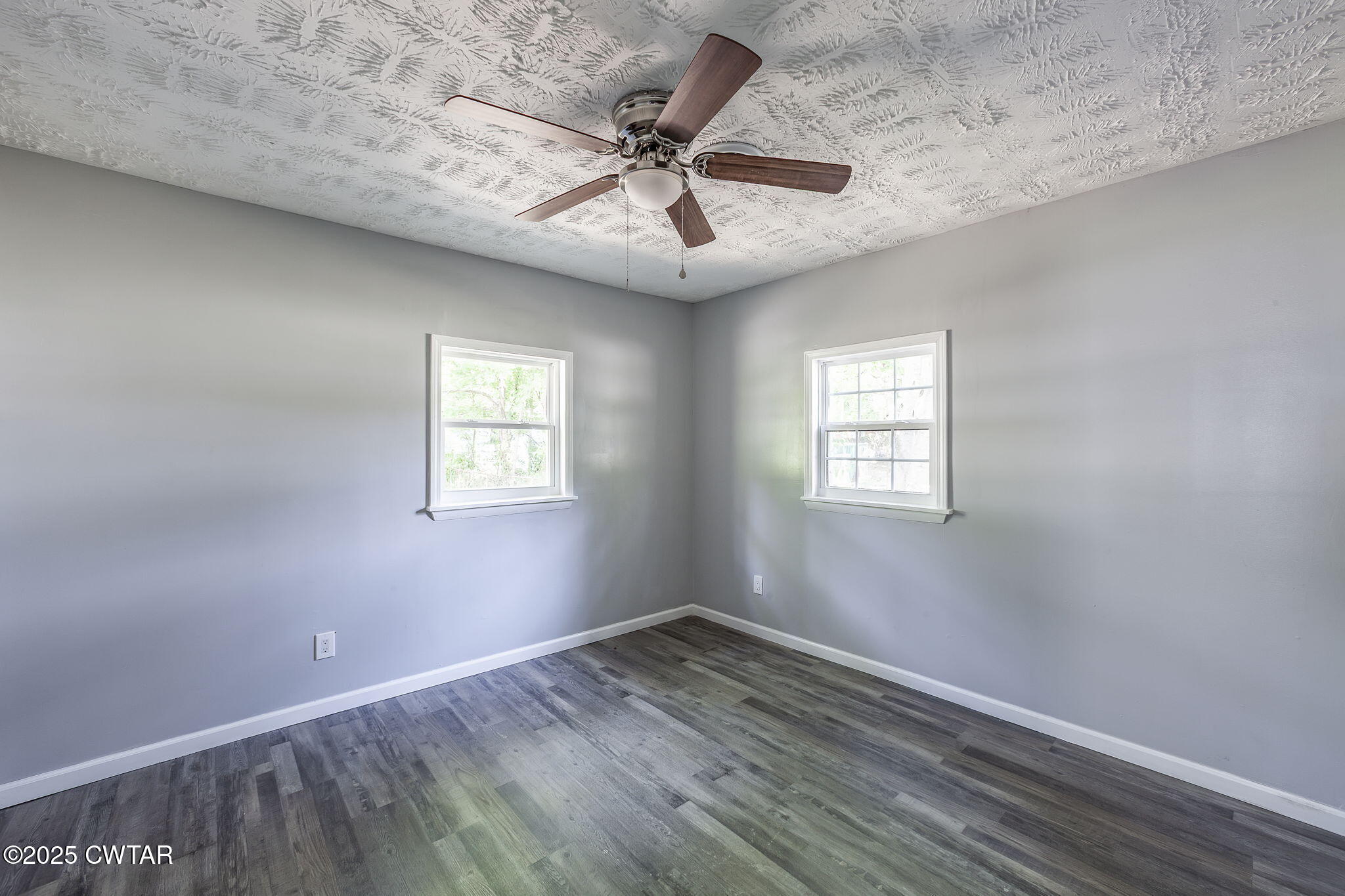 115 Neff Street Jackson, TN 38301 - Photo 18 of 23 an empty room with a window and a ceiling fan