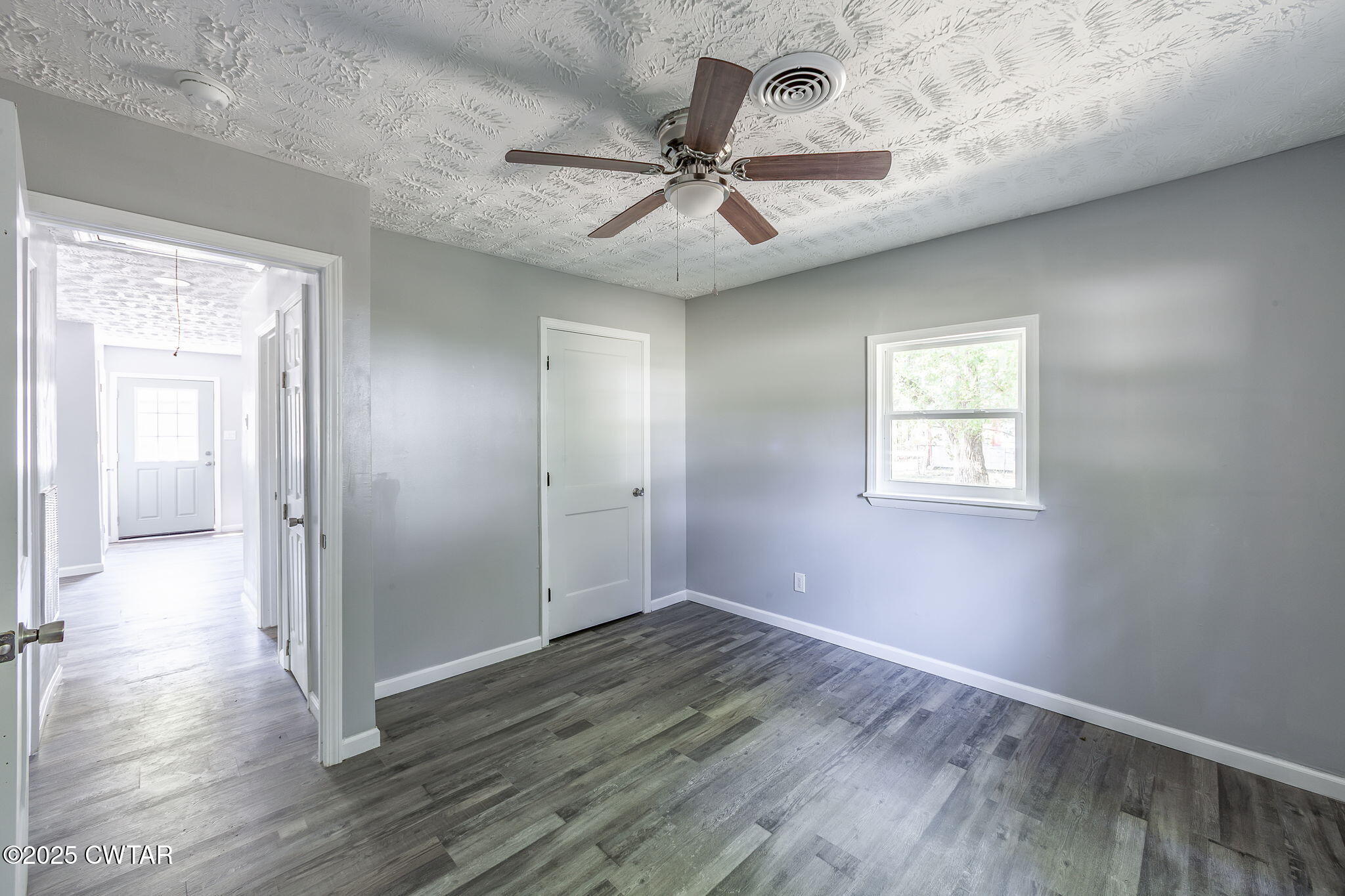 115 Neff Street Jackson, TN 38301 - Photo 19 of 23 wooden floor in an empty room with a window