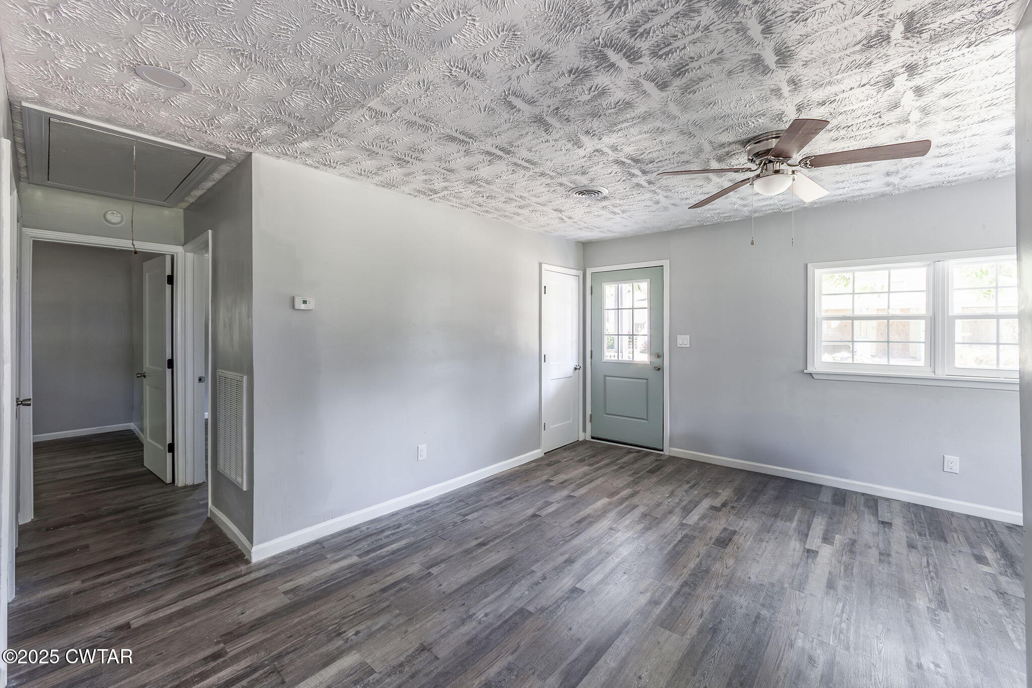 115 Neff Street Jackson, TN 38301 - Photo 10 of 23 a view of an empty room with wooden floor and a window