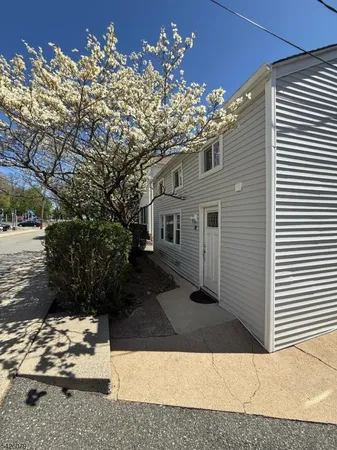 a view of roof deck with wooden fence and trees