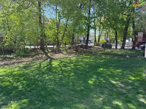 a view of a white house with a trees
