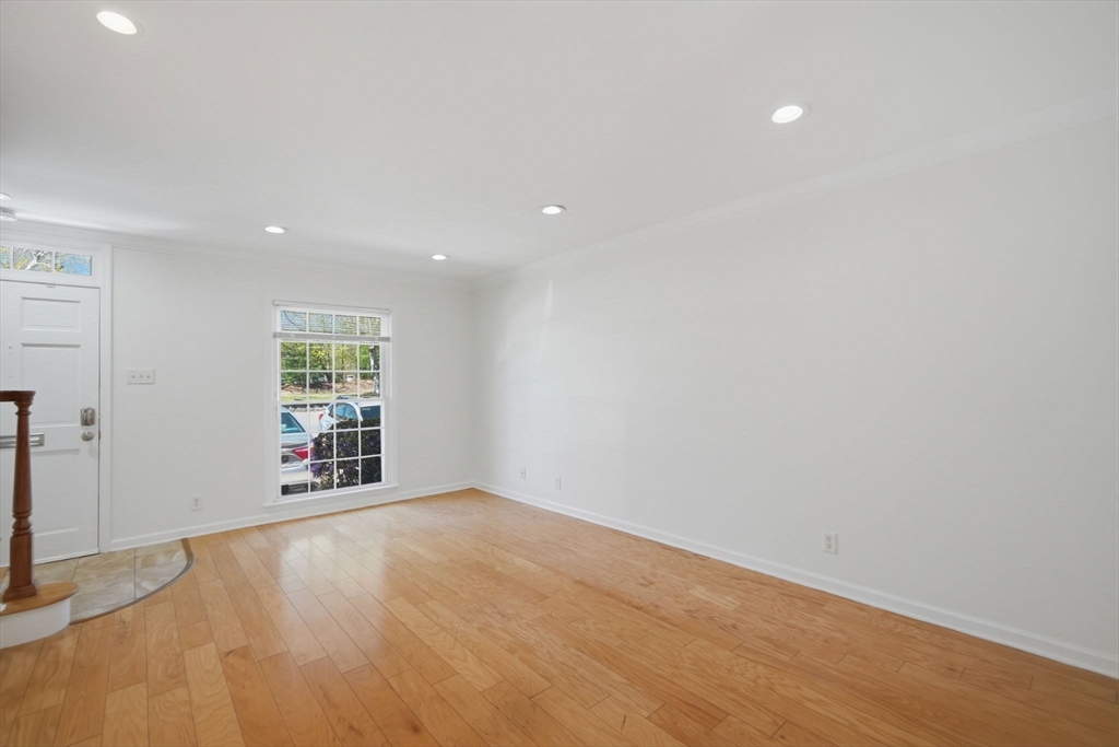 1155 Dickinson Street, Unit 1155 Springfield, MA 01108 - Photo 11 of 29 wooden floor in an empty room with a window