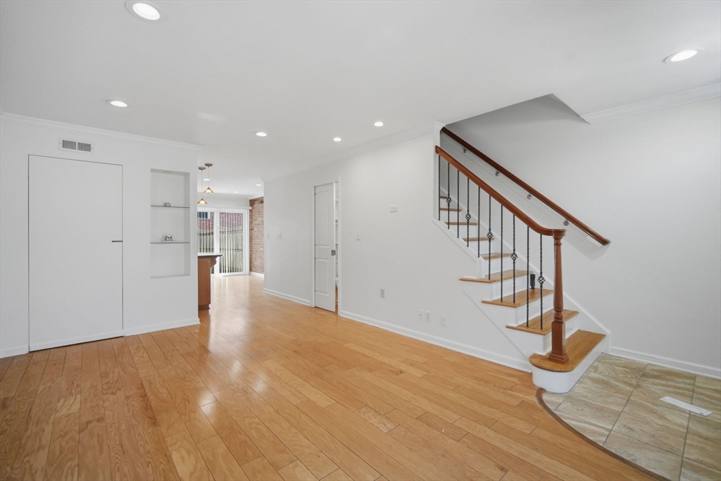 1155 Dickinson Street, Unit 1155 Springfield, MA 01108 - Photo 14 of 29 a view of empty room with wooden floor and fan