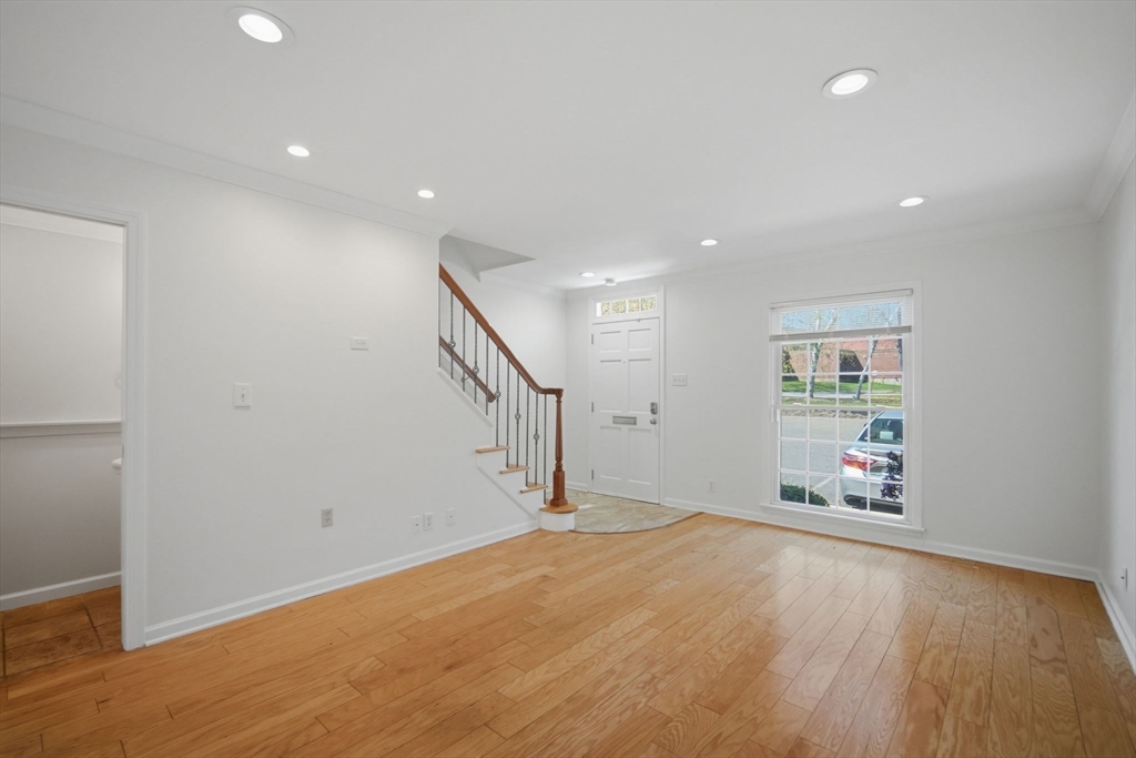 1155 Dickinson Street, Unit 1155 Springfield, MA 01108 - Photo 15 of 29 a view of an empty room with wooden floor and a window