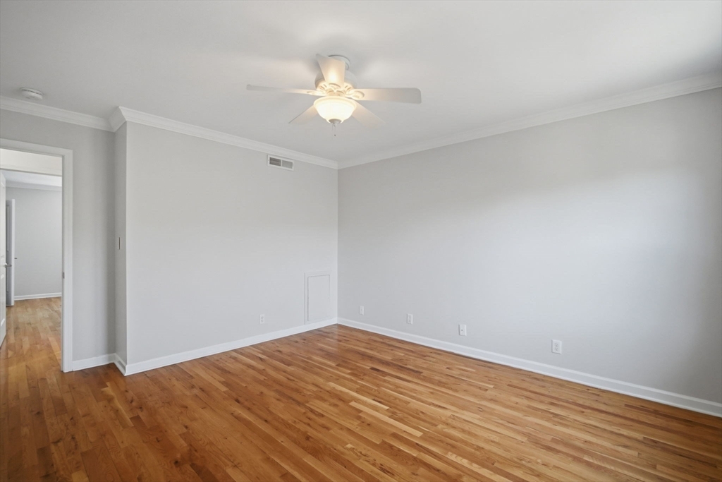 1155 Dickinson Street, Unit 1155 Springfield, MA 01108 - Photo 17 of 29 a view of a room with wooden floor and chandelier fan