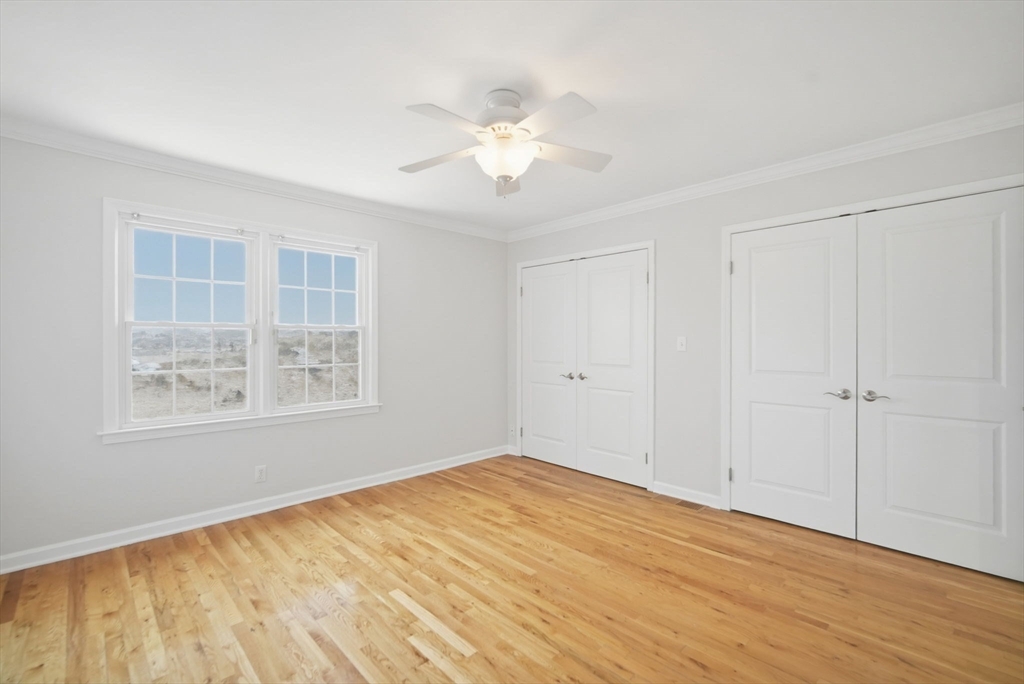 1155 Dickinson Street, Unit 1155 Springfield, MA 01108 - Photo 19 of 29 a view of an empty room with wooden floor and a window