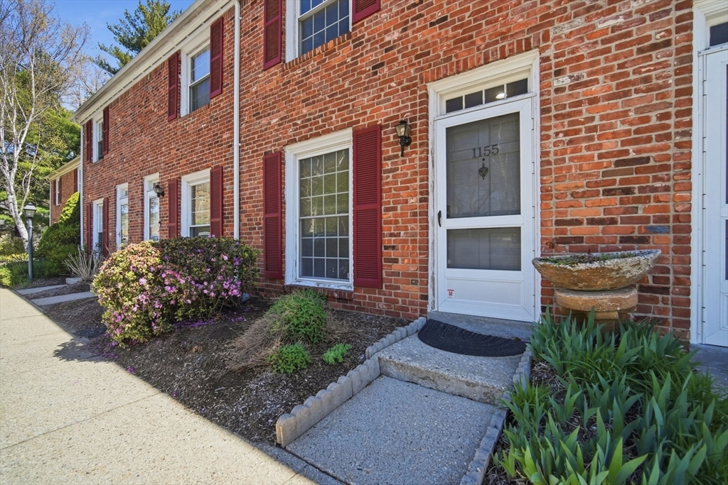 1155 Dickinson Street, Unit 1155 Springfield, MA 01108 - Photo 2 of 29 a front view of a house with a garden