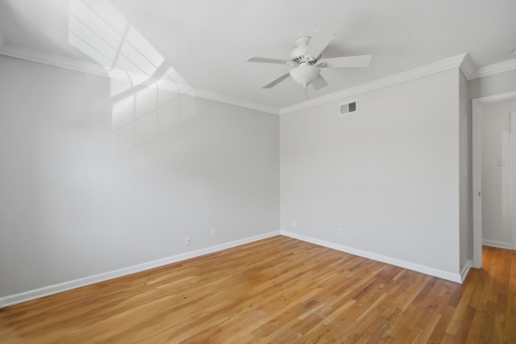 1155 Dickinson Street, Unit 1155 Springfield, MA 01108 - Photo 23 of 29 a view of a room with wooden floor and a ceiling fan