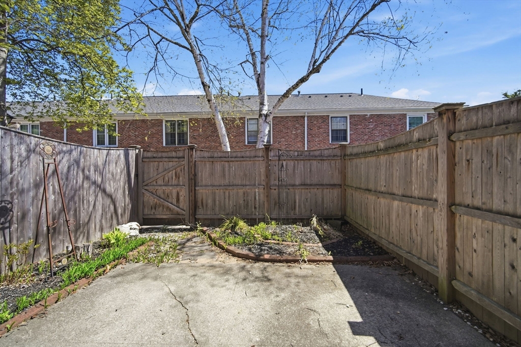 1155 Dickinson Street, Unit 1155 Springfield, MA 01108 - Photo 27 of 29 a view of a small house with wooden fence