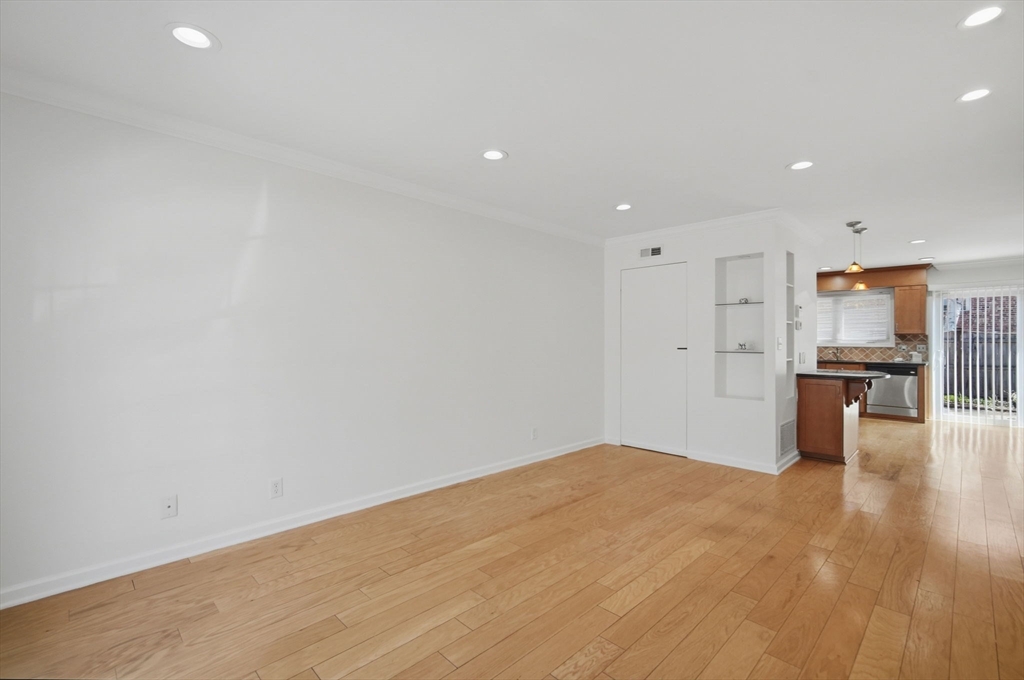 1155 Dickinson Street, Unit 1155 Springfield, MA 01108 - Photo 10 of 29 a view of kitchen with kitchen island wooden floor center island and stainless steel appliances