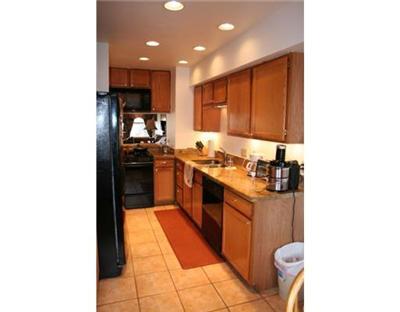 460 Moonridge Drive, Unit E2 Edwards, CO 81632 - Photo 5 of 12 a kitchen with stainless steel appliances granite countertop a sink and a stove