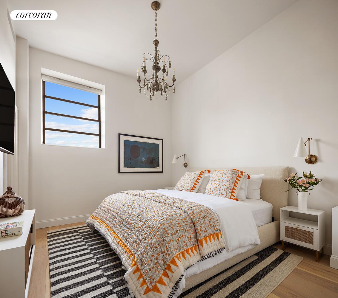 35 Bethune Street, Unit PHB Manhattan, NY 10014 - Photo 9 of 13 a bedroom with bed and a chandelier
