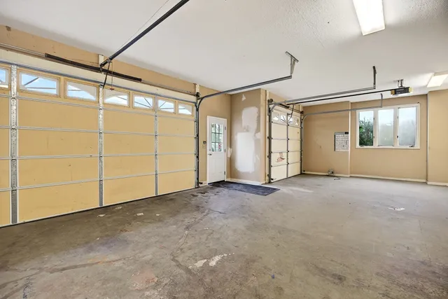 a view of a livingroom with a flat screen tv and floor to ceiling window