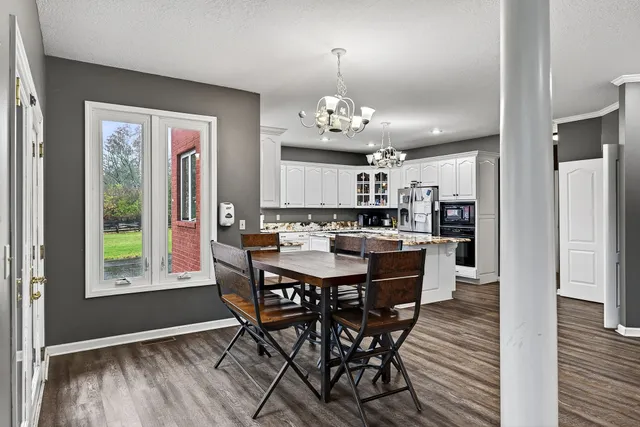 a kitchen with a table chairs stove and cabinets