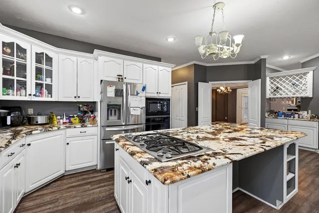 a kitchen with a stove a sink and a refrigerator