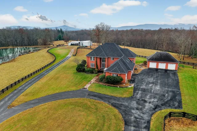 an aerial view of a swimming pool with a mountain view