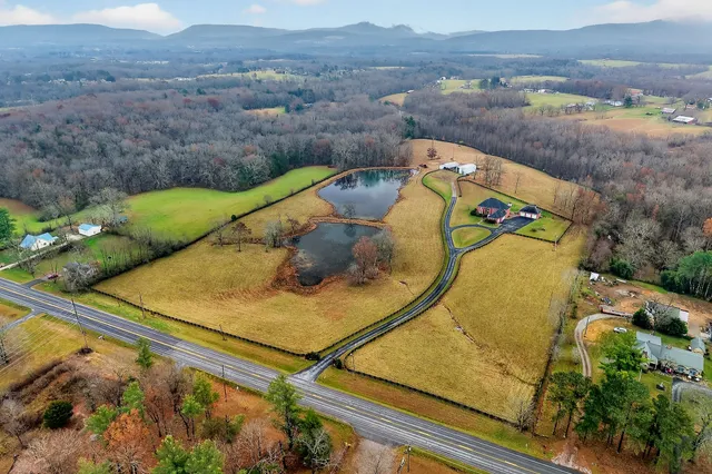 a view of a house with a yard and sitting area