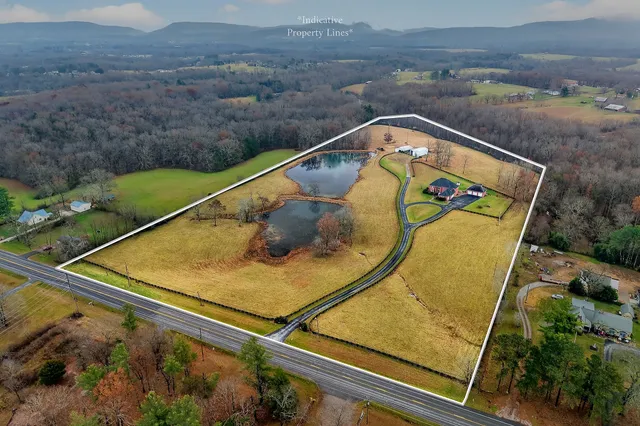 a view of a lake with a yard and trees
