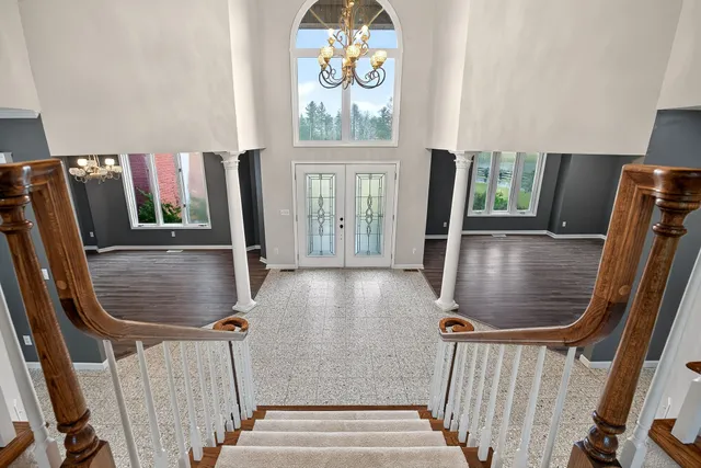 an empty room with windows and fireplace