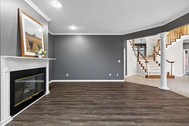 a bathroom with a granite countertop sink a toilet and a window