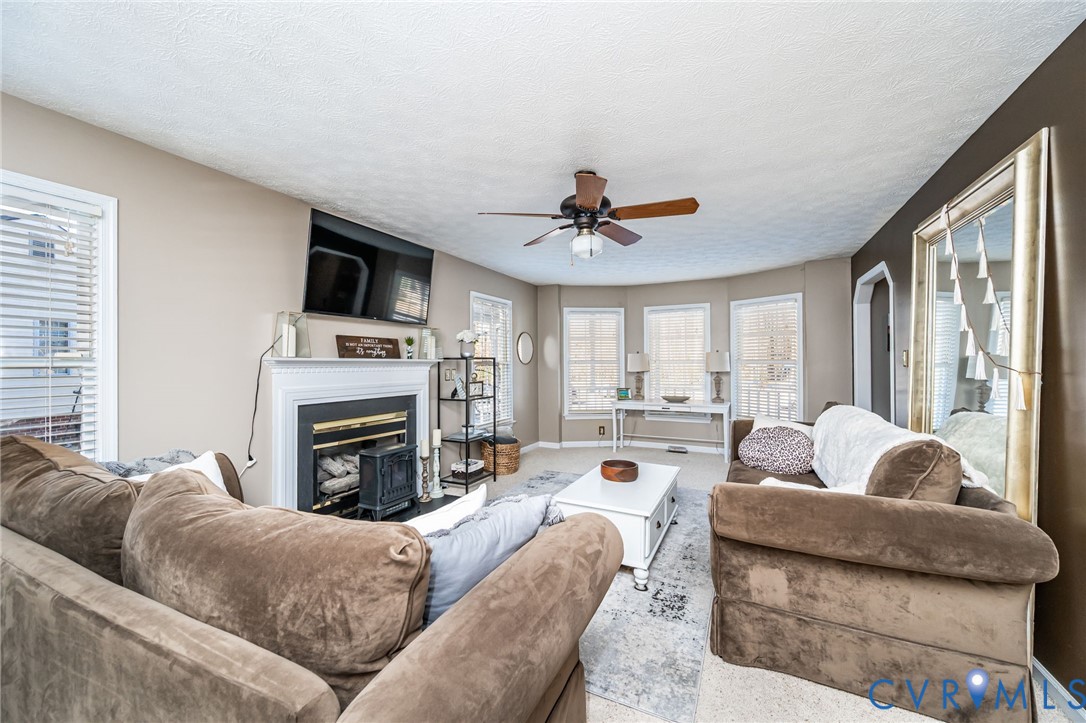 2423 Brookforest Road Midlothian, VA 23112 - Photo 11 of 40 a living room with furniture a fireplace and a flat screen tv