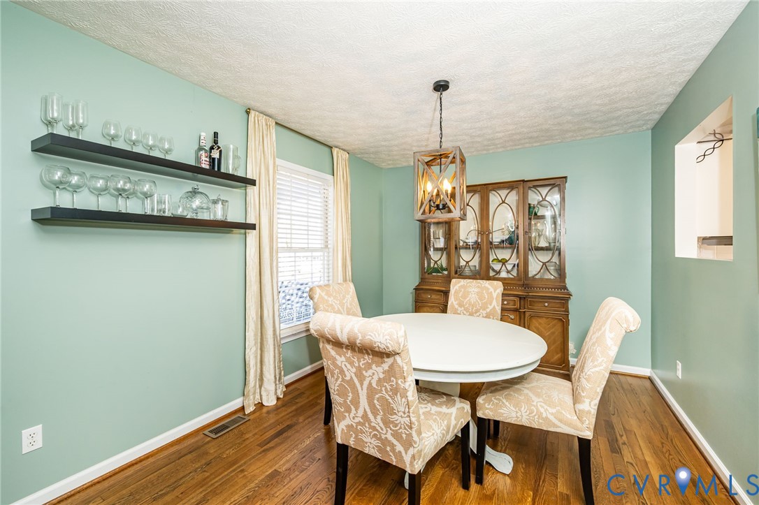 2423 Brookforest Road Midlothian, VA 23112 - Photo 14 of 40 a view of a dining room with furniture and wooden floor