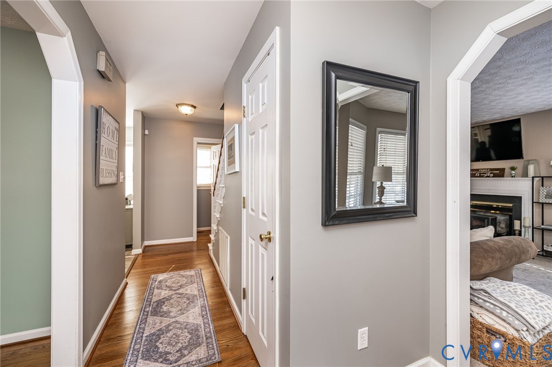 2423 Brookforest Road Midlothian, VA 23112 - Photo 16 of 40 a view of a hallway with wooden floor and a living room