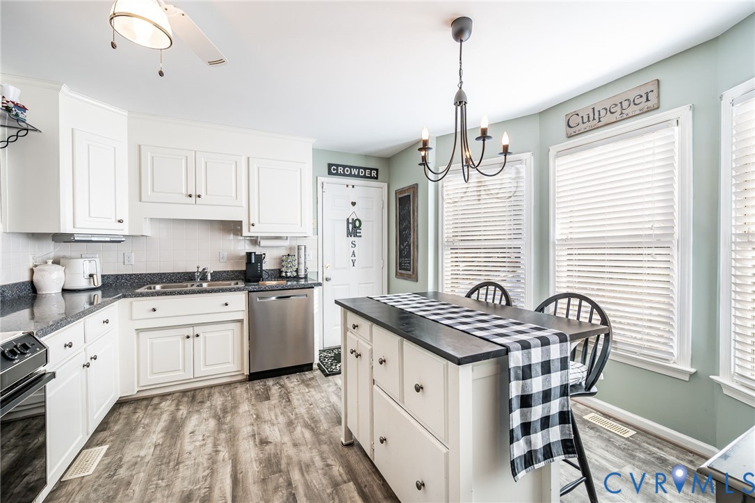 2423 Brookforest Road Midlothian, VA 23112 - Photo 17 of 40 a kitchen with stainless steel appliances granite countertop a stove a sink and a refrigerator