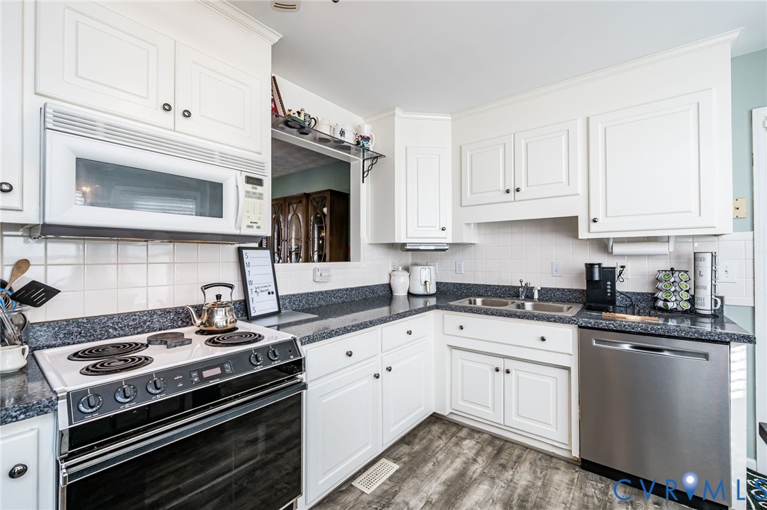 2423 Brookforest Road Midlothian, VA 23112 - Photo 18 of 40 a kitchen with granite countertop a stove sink and cabinets