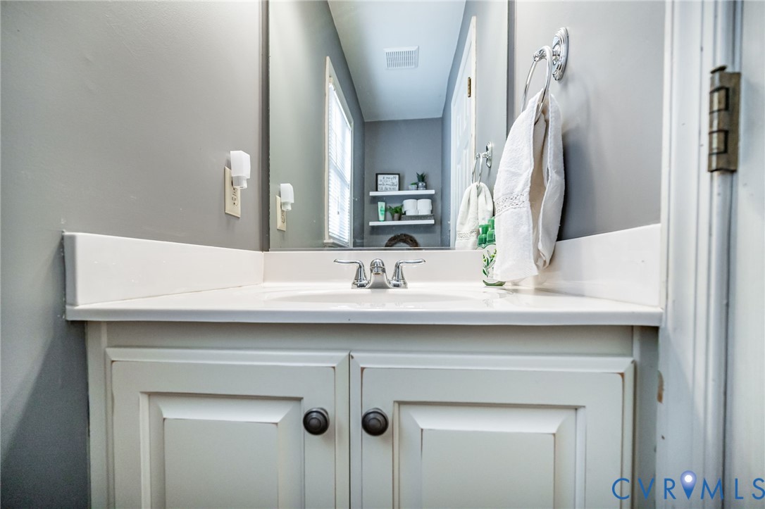 2423 Brookforest Road Midlothian, VA 23112 - Photo 22 of 40 a bathroom with a sink and a mirror