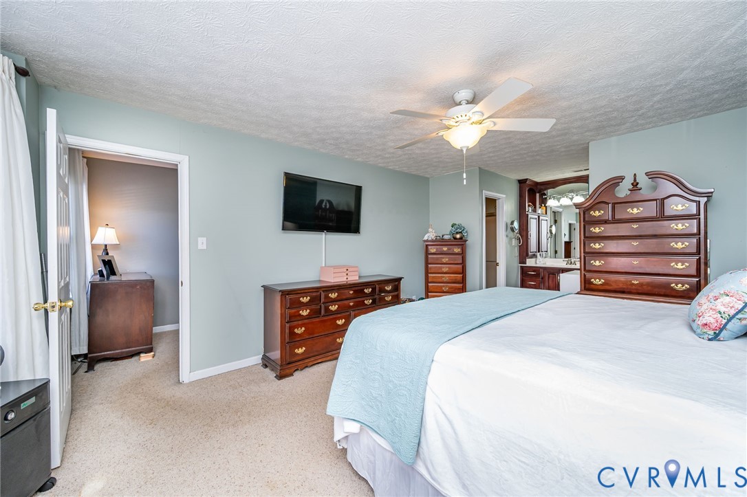 2423 Brookforest Road Midlothian, VA 23112 - Photo 25 of 40 a bedroom with a bed and a flat screen tv