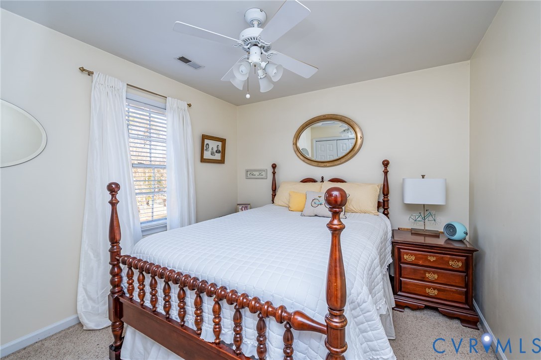 2423 Brookforest Road Midlothian, VA 23112 - Photo 28 of 40 a bedroom with a bed mirror and a window