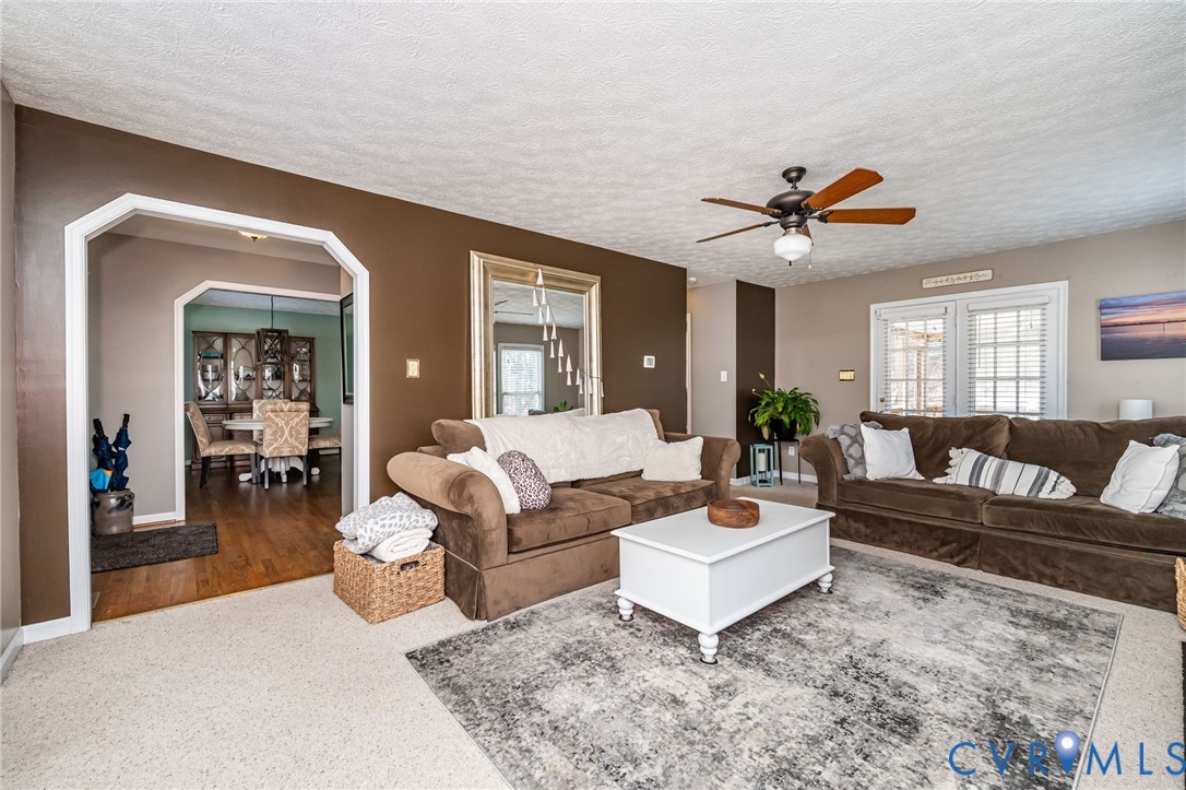 2423 Brookforest Road Midlothian, VA 23112 - Photo 10 of 40 a living room with furniture ceiling fan and a rug