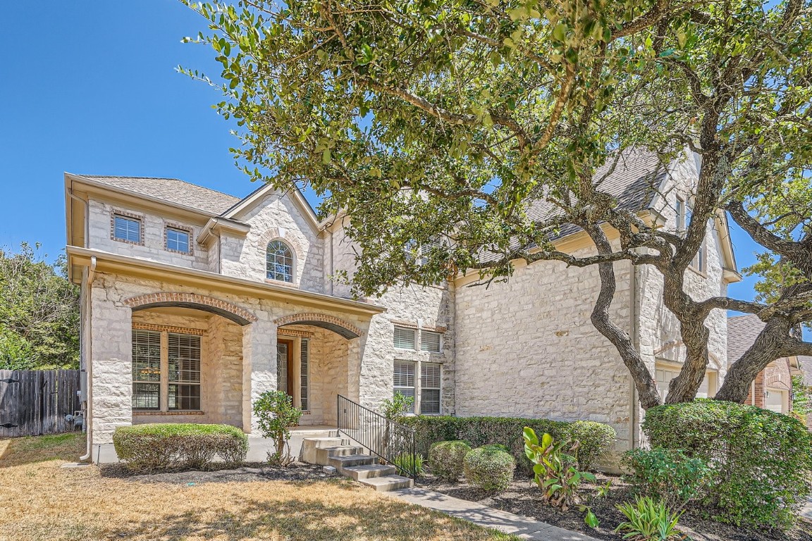 front view of a house with a tree