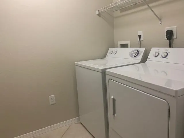 a living room with furniture a chandelier and a large mirror