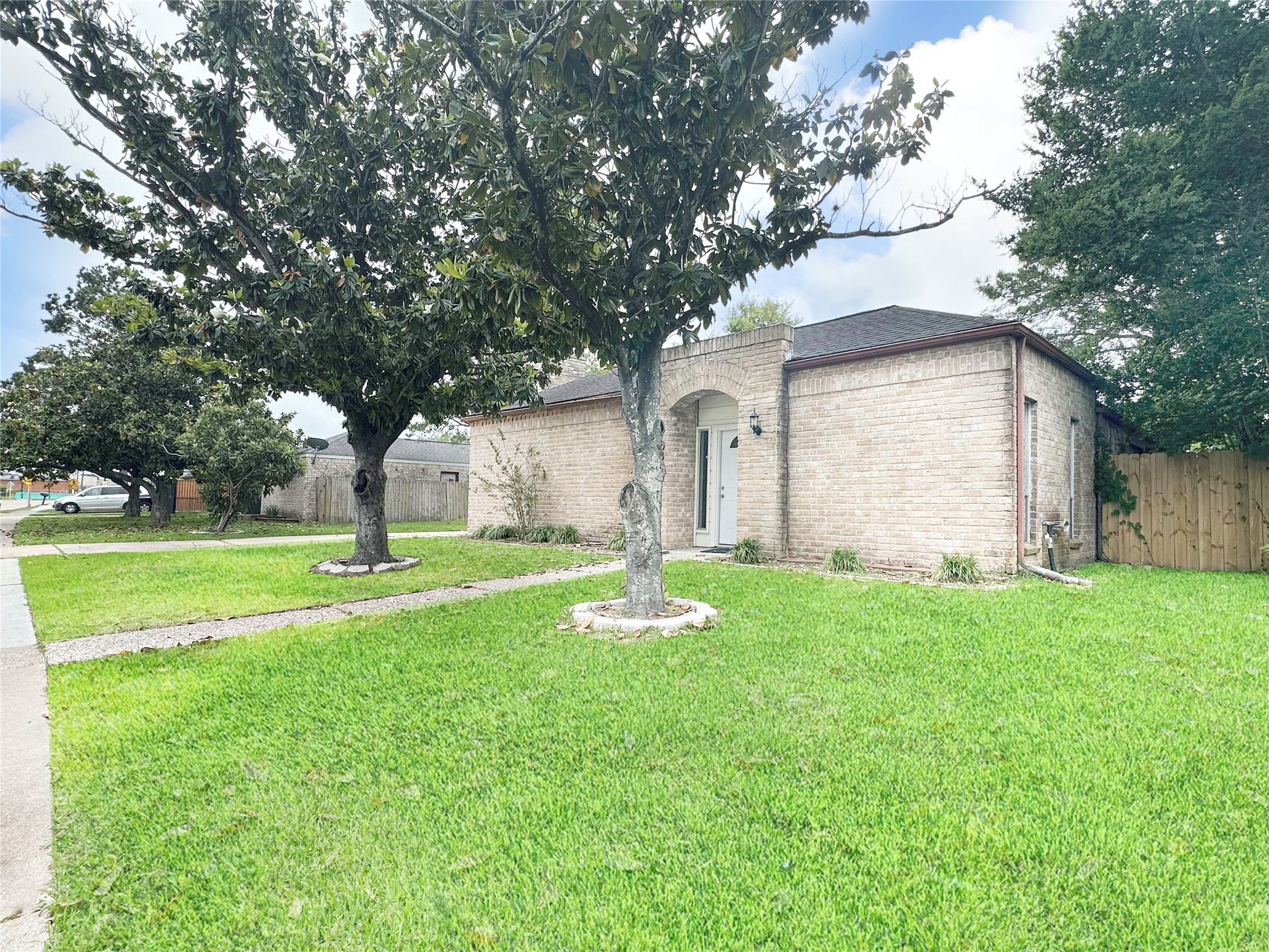 6806 Winkleman Road Houston, TX 77083 - Photo 2 of 29 a front view of a house with garden