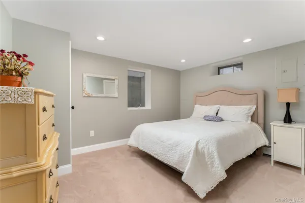 a bedroom with a bed and a refrigerator